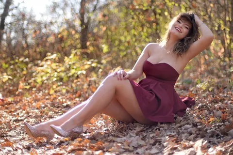 Carolina Rayne: Busty Brunette in a Dress and Heels Poses Among the Trees – photo 10 of 15