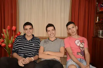 Three Slim Brunette Guys Kiss and Fuck on the Sofa