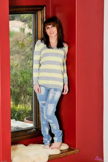 Brunette in Jeans Poses and Shows Her Tattooed Body