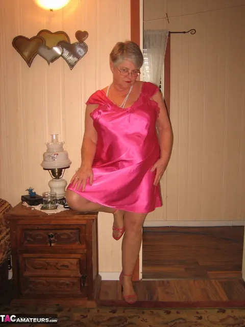 Silver-Haired Woman Pulls Down Her Pantyhose on the Bed – photo 2 of 20