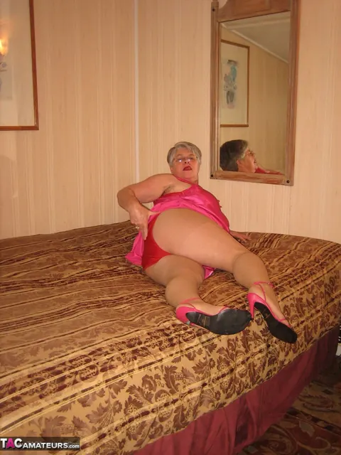Silver-Haired Woman Pulls Down Her Pantyhose on the Bed – photo 8 of 20