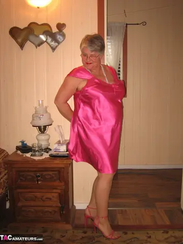 Silver-Haired Woman Pulls Down Her Pantyhose on the Bed