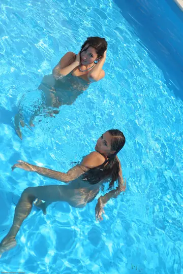Brunette and Redhead Lesbians Kiss by the Pool Outdoors