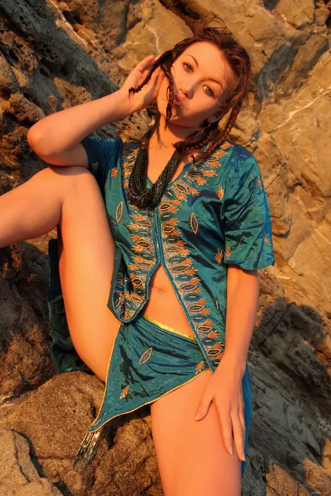Woman Strips Nude, Kneels, and Arches Back for the Camera – photo 3 of 21