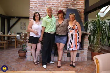 Busty Blonde MILF in a Skirt and Panties Sucks Cock in a Group