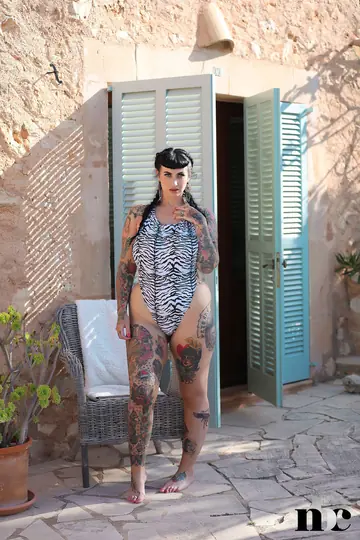 BBW with Tattoos and Piercings Strips Nude Outdoors