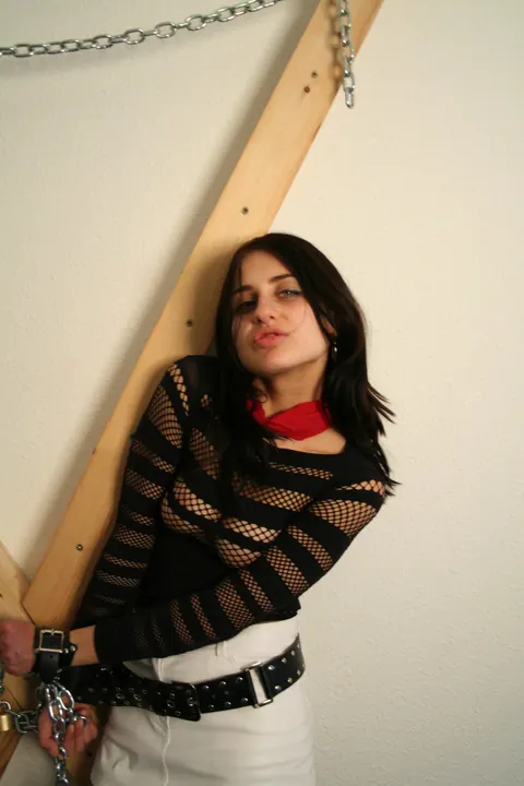 Brunette in a Latex Skirt and Boots Restrained with a Cleave Gag – photo 16 of 16