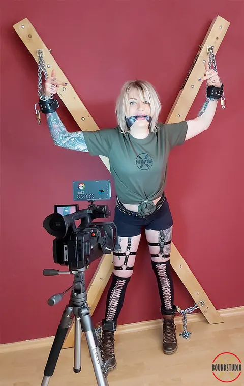 Tattooed Blonde Bound to a Cross in Shorts and Socks – photo 13 of 16