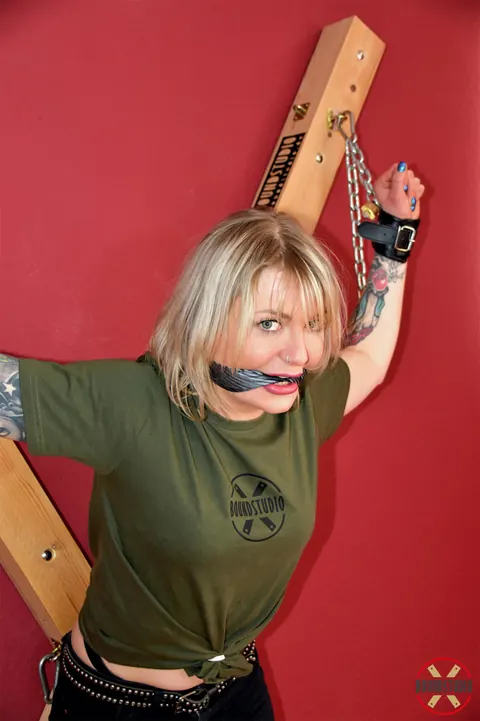 Tattooed Blonde Bound to a Cross in Shorts and Socks – photo 2 of 16