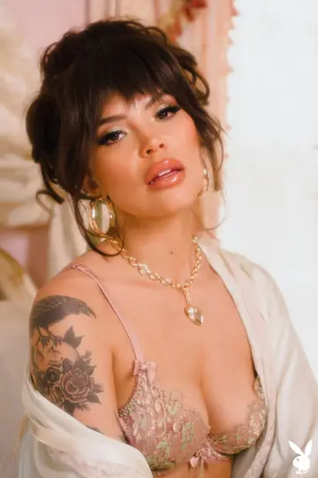 Tattooed Brunette in Glasses Strips and Poses Nude