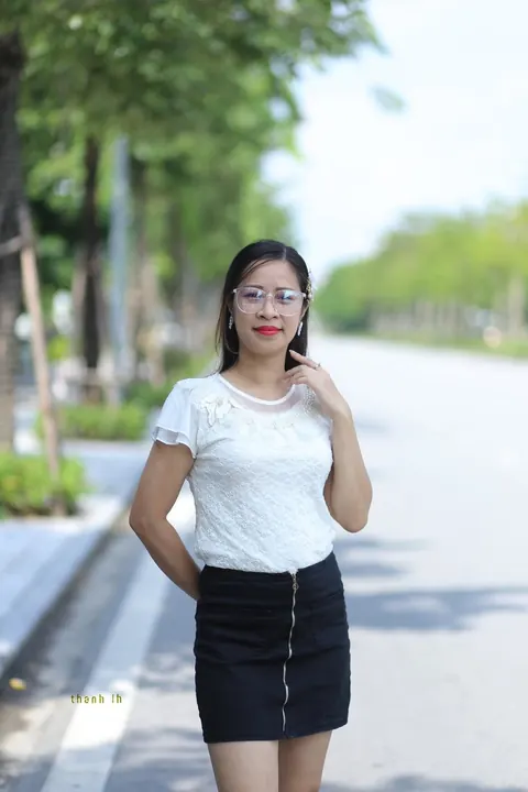 Asian Brunette in a Skirt and Glasses Poses Outdoors – photo 4 of 21
