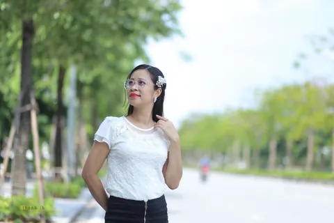 Asian Brunette in a Skirt and Glasses Poses Outdoors – photo 2 of 21