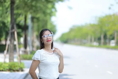 Asian Brunette in a Skirt and Glasses Poses Outdoors – photo 3 of 21