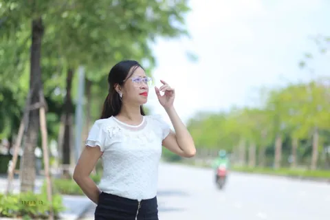 Asian Brunette in a Skirt and Glasses Poses Outdoors – photo 1 of 21