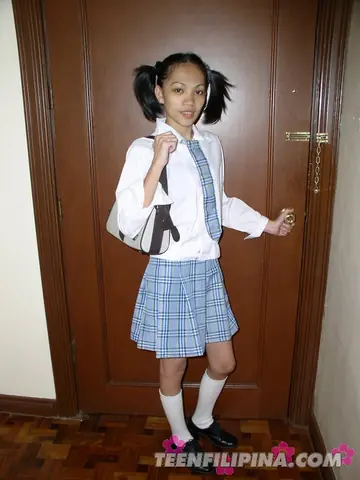 Skinny Asian Babe in a Skirt and Socks Spreads Her Shaved Pussy on the Sofa