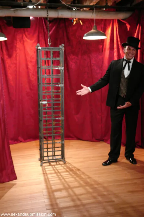 Soolin Kelter: Slim Korean MILF in a Skirt Bound and Caged During a Magic Show – photo 19 of 20