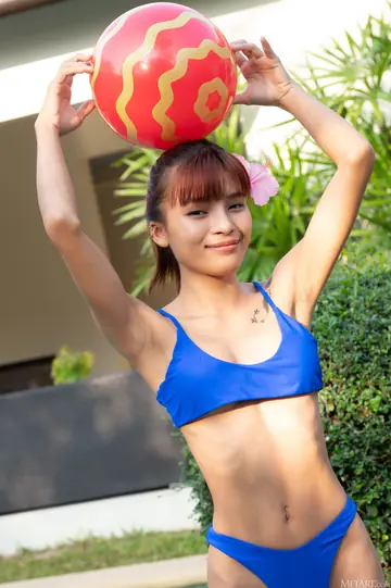 Asian Woman Strips Out of Her Bikini and Oils Up by the Pool