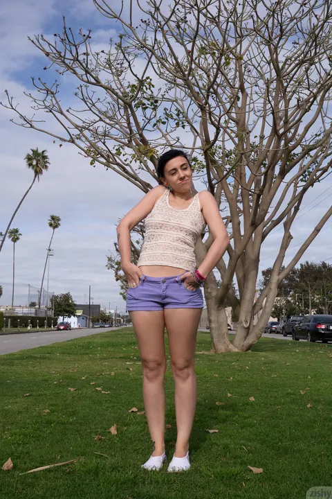 Aysha Thoen: Petite Brunette in Shorts Flashes Her Big Tits in Public Park – photo 11 of 12