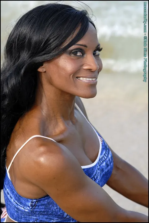 Debra Dunn: Busty Ebony MILF Flexes Her Muscles in a Bikini and Jeans on the Beach – photo 12 of 15