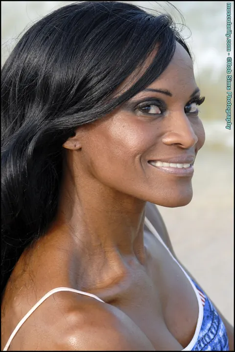 Debra Dunn: Busty Ebony MILF Flexes Her Muscles in a Bikini and Jeans on the Beach – photo 14 of 15