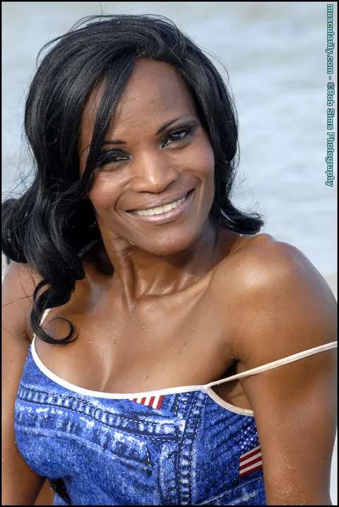 Debra Dunn: Busty Ebony MILF Flexes Her Muscles in a Bikini and Jeans on the Beach – photo 15 of 15