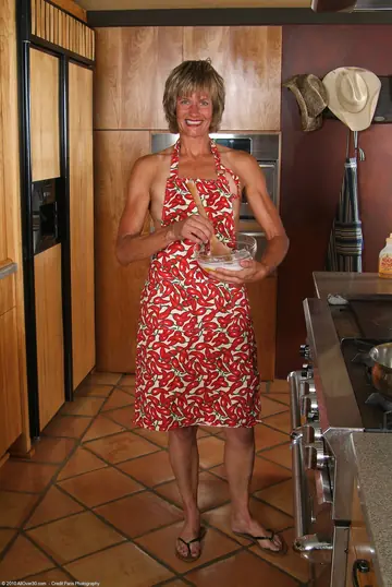 Short-Haired MILF Spreads Her Shaved Pussy in the Kitchen