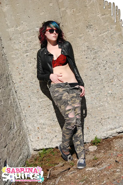Sabrina Squirts: Brunette in Glasses Lowers Camouflage Pants Outdoors – photo 2 of 12