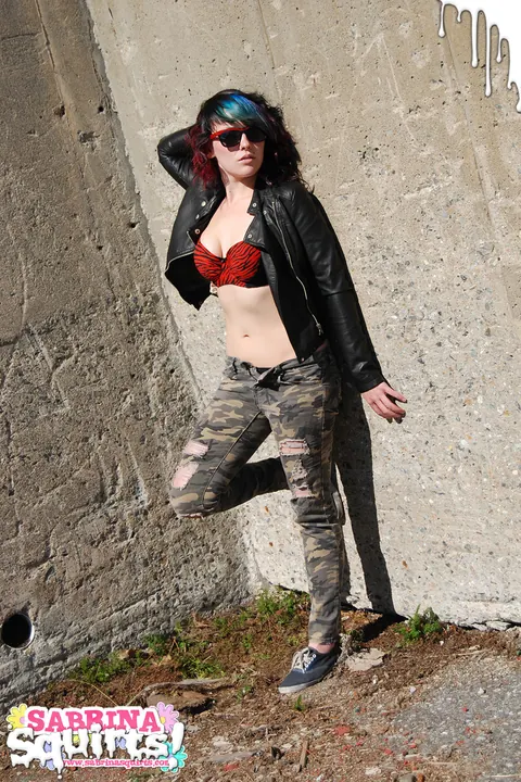 Sabrina Squirts: Brunette in Glasses Lowers Camouflage Pants Outdoors – photo 1 of 12