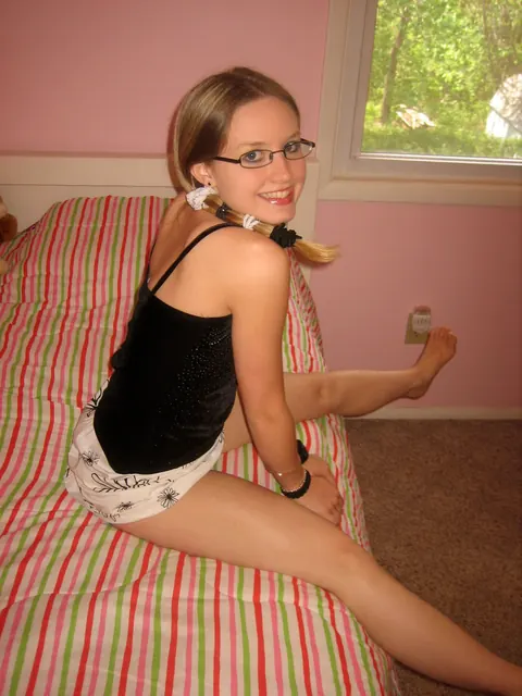 Petite Brunette in Glasses Strips and Fingers Her Pussy – photo 2 of 20