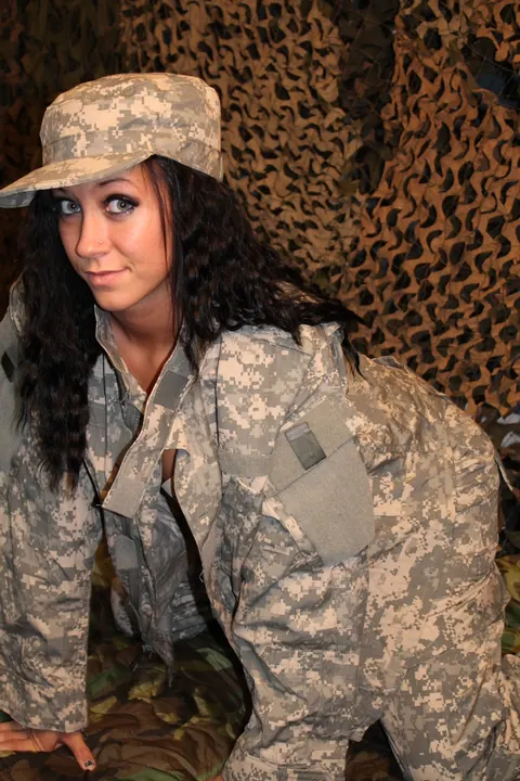 Woman Strips Off Her Military Uniform to Reveal Lingerie – photo 8 of 16
