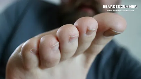 Man Lifts His Foot to His Mouth on the Sofa – photo 13 of 15