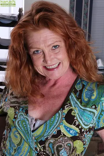 Mature Redhead in Lingerie and Stockings Fingers Her Shaved Pussy