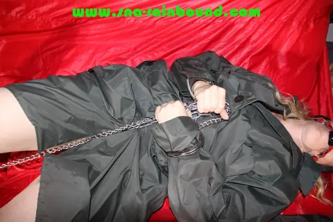 Thick Blonde Fastens Chains on Herself in Raincoat and Boots – photo 10 of 16