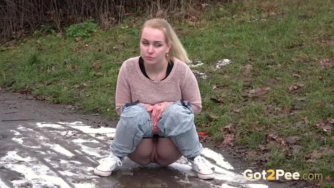 Woman Pulls Down Her Jeans and Spreads Her Shaved Pussy to Pee Outdoors – photo 14 of 15