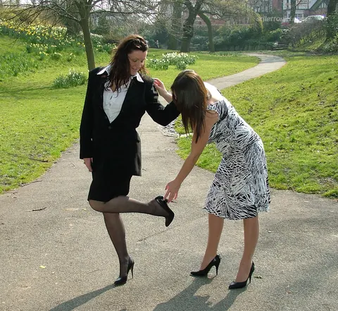 Two Women in Skirts, Stockings and Heels Kiss Outdoors – photo 10 of 16