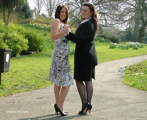 Two Women in Skirts, Stockings and Heels Kiss Outdoors – photo 16 of 16