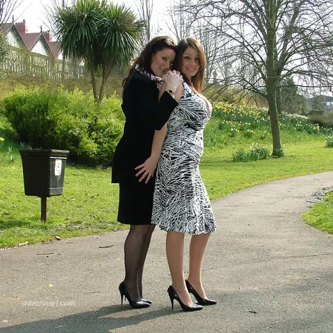 Two Women in Skirts, Stockings and Heels Kiss Outdoors – photo 14 of 16