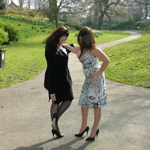 Two Women in Skirts, Stockings and Heels Kiss Outdoors – photo 12 of 16