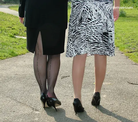 Two Women in Skirts, Stockings and Heels Kiss Outdoors – photo 3 of 16