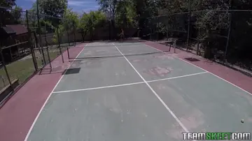 Tattooed Athletic Brunette Gives a Blowjob on Tennis Court