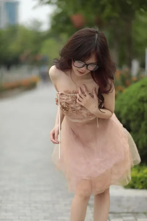 Asian Redhead in a Dress and Glasses Poses Outdoors – photo 5 of 21