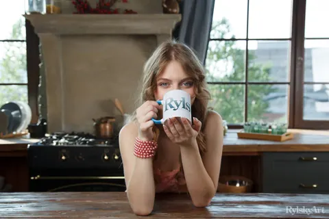 Woman Strips Nude on the Kitchen Table Beside Coffee – photo 4 of 16