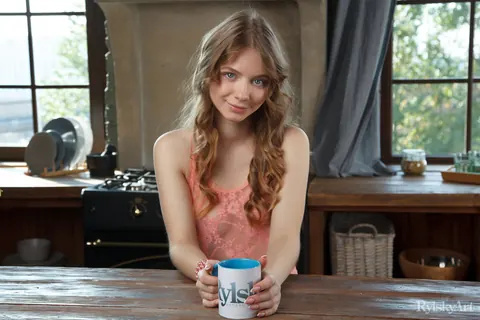 Woman Strips Nude on the Kitchen Table Beside Coffee – photo 2 of 16