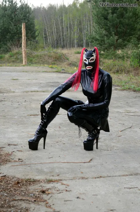 RubberDoll: Busty Brunette Poses in Latex Costume and High Heels Outdoors – photo 13 of 15