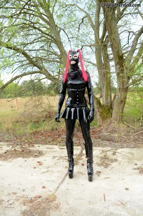 RubberDoll: Busty Brunette Poses in Latex Costume and High Heels Outdoors – photo 8 of 15
