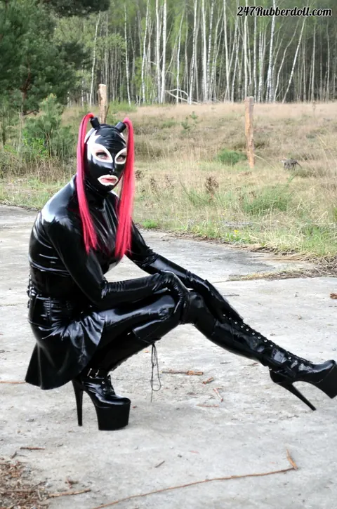 RubberDoll: Busty Brunette Poses in Latex Costume and High Heels Outdoors – photo 15 of 15