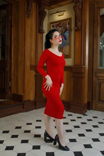 Slim Brunette in a Dress and Glasses Spreads Her Pussy