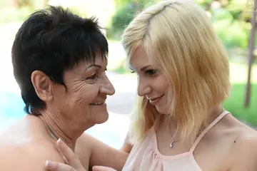 Mature Brunette in a Bikini Seduces Short-Haired Woman for Lesbian Sex