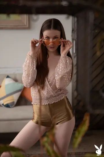 Brunette with Natural Tits Undresses and Poses Nude on the Sofa