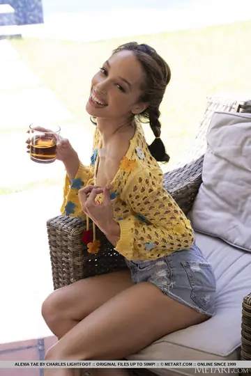 Ebony Brunette with Pigtails Strips and Poses on a Backyard Chair